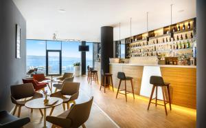 a restaurant with tables and chairs and a bar at Hotel Istra - Liburnia in Opatija