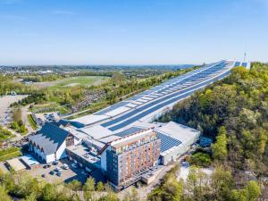 an overhead view of a building and a highway at Alpine Hotel by SnowWorld in Landgraaf