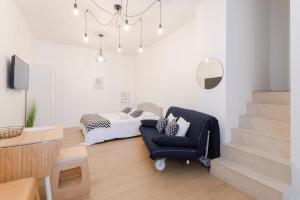 a bedroom with a bed and a blue chair at Studio Family Marseille Parking Clim - MaisonMars in Marseille
