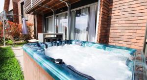 a bath tub filled with snow in front of a house at Plein Soleil avec Jacuzzi Privatif et parking priv&eacute; in Sarlat-la-Can&eacute;da