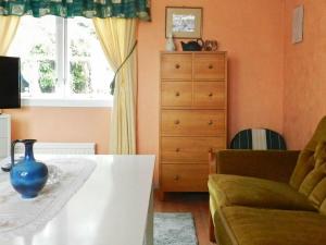 a living room with a table and a couch and a window at 2 person holiday home in LYSEKIL in Lysekil