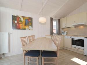 a kitchen with a table and chairs in a room at 4 person holiday home in GROEMITZ in Grömitz