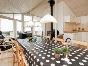 a dining room table with a black and white polka dot table cloth at 4 person holiday home in Otterup in Otterup