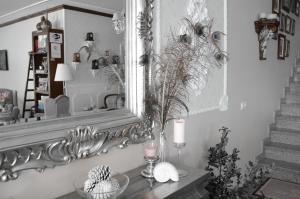 a mirror on a wall next to a table with a candle at Casa A Pastora in Cambados