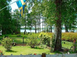 a kite flying in the air next to a tree at 5 person holiday home in H SSLEHOLM in Hässleholm