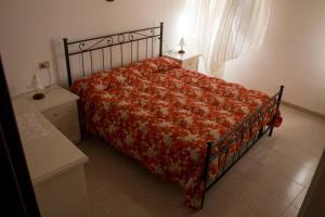 a bedroom with a bed with a red comforter at Appartamento Gio B in Tignale