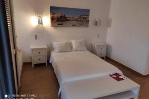 a small bedroom with two beds and two night stands at Fabulous Sea view Studio near old town Albufeira in Albufeira