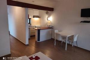 a small kitchen with a table and chairs in a room at Fabulous Sea view Studio near old town Albufeira in Albufeira