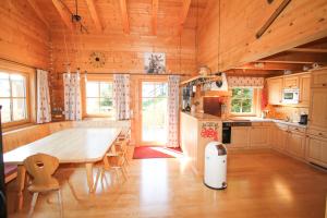 a kitchen with a large wooden table and chairs at Chalet Königsleiten 168 in Königsleiten