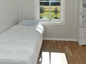 a bed in a room with a window at 8 person holiday home in Oksvoll in Oksvoll