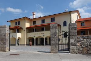 a large building with a gate in front of it at Hotel Malovec in Divača