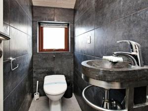 a bathroom with a sink and a toilet at 8 person holiday home in Dannemare in Dannemare