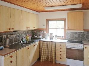 a kitchen with a sink and a stove top oven at Holiday Home Brunkelstorp in Osby