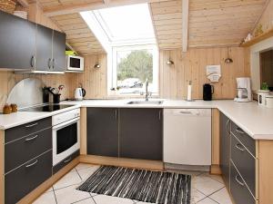 a kitchen with a sink and a stove top oven at 5 person holiday home in lb k in Ålbæk