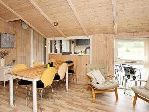 a kitchen and dining room with a table and chairs at 5 person holiday home in lb k in Ålbæk