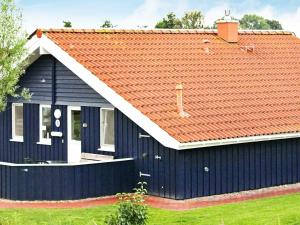 a blue house with an orange roof at 6 person holiday home in Otterndorf in Otterndorf