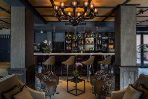 a bar in a hotel with chairs and a chandelier at Carnival Palace - Venice Collection in Venice