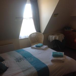 A bed or beds in a room at Cleasewood Guest House 