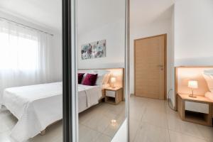Postel nebo postele na pokoji v ubytování Apartments Diora