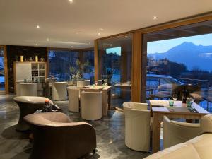 
a living room with a couch, chairs and a table at Chalet Grand Loup in Nendaz
