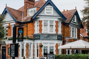 a large brick house with a sign in front of it at Inn in the Park in Bournemouth