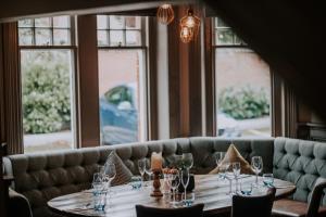 a dining room with a table with wine glasses at Inn in the Park in Bournemouth