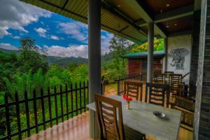 a porch with a table and chairs and a view at Zircon Ella in Ella