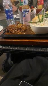 a tray of food on a table with a plate of food at Riverside Hotel Kalam in Kārandūkai