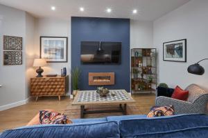 a living room with a blue couch and a table at Host & Stay - Green View in Harrogate