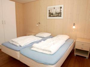 a bedroom with two beds with towels on them at Modern Holiday Home in Aakirkeby with Sauna in Vester Sømarken