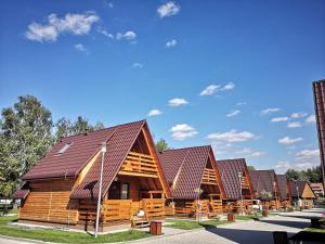 a row of log homes with brown roofs at Przystań - Aktywna strona Iłży in Iłża