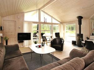 a living room with a couch and a table at Seaside Haven Retreat - By Traum Ferienwohnungen in Skram