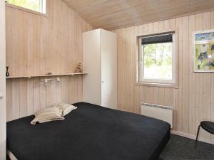 a bedroom with a large black bed in a room at Seaside Haven Retreat - By Traum Ferienwohnungen in Skram