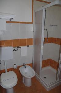 a bathroom with a shower and a toilet and a sink at Hotel San Martino in Cassibile