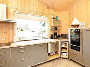 een keuken met een wastafel en een raam bij 8 person holiday home in Fan in Fanø