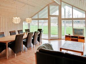 a dining room with a table and chairs at 14 person holiday home in Idestrup in Marielyst