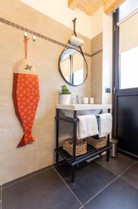 a bathroom with a large orange fish painting on the wall at Fashionhouse in La Spezia
