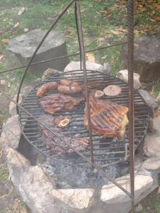 a grill with meat and other food on it at Angelina's House by L&L in Mar del Plata