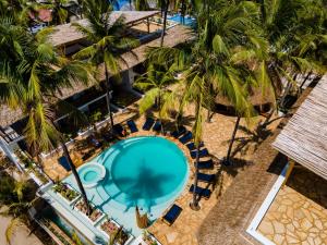 an overhead view of the pool at a resort with palm trees at Aluna Paje in Paje
