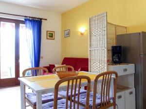 a kitchen and dining room with a table and chairs at Apartment Villa Rizzardi-1 by Interhome in Malcesine +11 photos