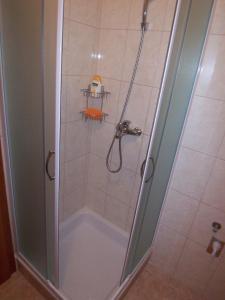 a shower with a glass door in a bathroom at Apartments Croatia Brač in Supetar