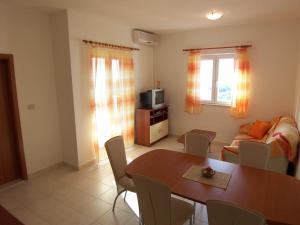 a living room with a table and a couch at Apartments Croatia Brač in Supetar