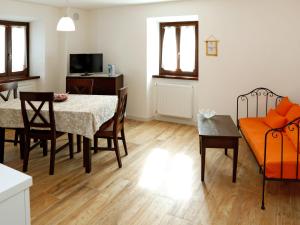 een woonkamer met een tafel en een bank bij Apartment Cjase da Maestre-2 by Interhome in Raveo