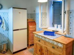 a kitchen with a white refrigerator and a counter at Holiday Home Dubravka by Interhome in Osor +19 photos