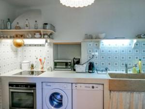 a kitchen with a washing machine and a sink at Holiday Home Dubravka by Interhome in Osor