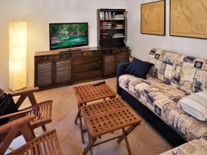 a living room with a couch and a tv at Holiday Home Dubravka by Interhome in Osor