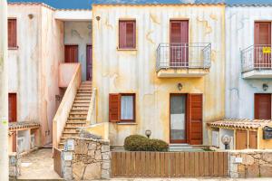 an old building with stairs in front of it at Shanti House Olbia in Olbia