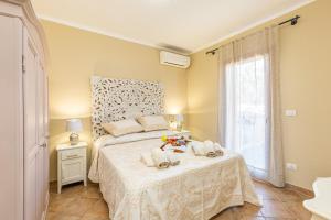 a bedroom with a bed with a white bedspread at Shanti House Olbia in Olbia