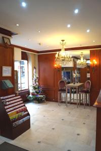 a living room with a christmas tree and a table at Hotel Havane Opera in Paris