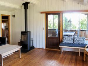 a living room with a couch and a wood stove at 6 person holiday home in Str by in Strøby